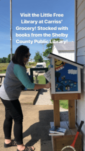 Restocking the Little Free Library at Carriss' Grocery
